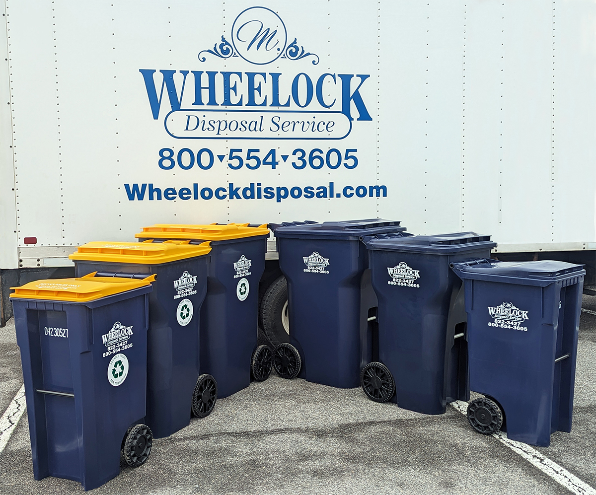 Wheelock garbage cans in front of truck